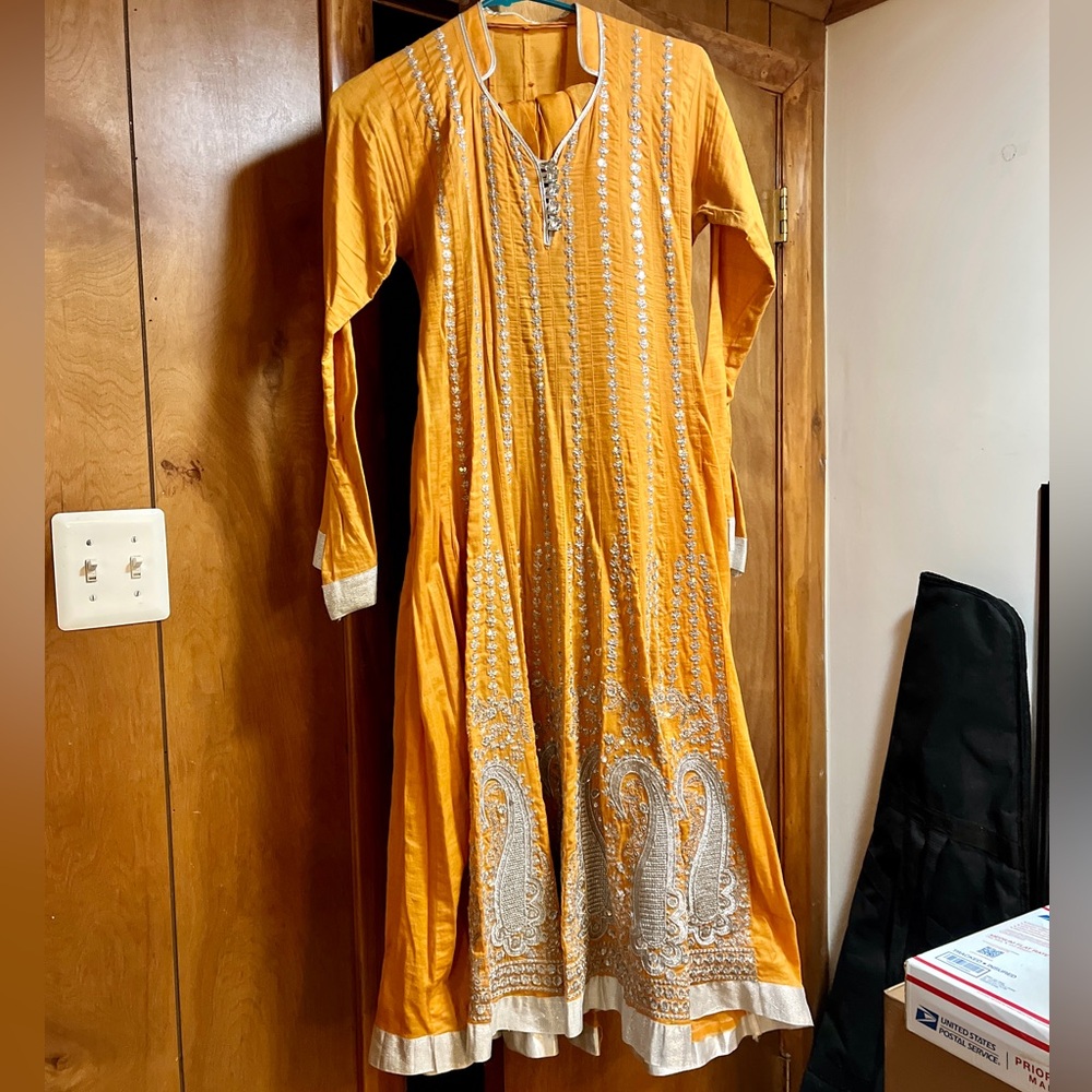 Beautiful orange anarkali dress comes with a scarf (dupatta) and pants (shalwar)
